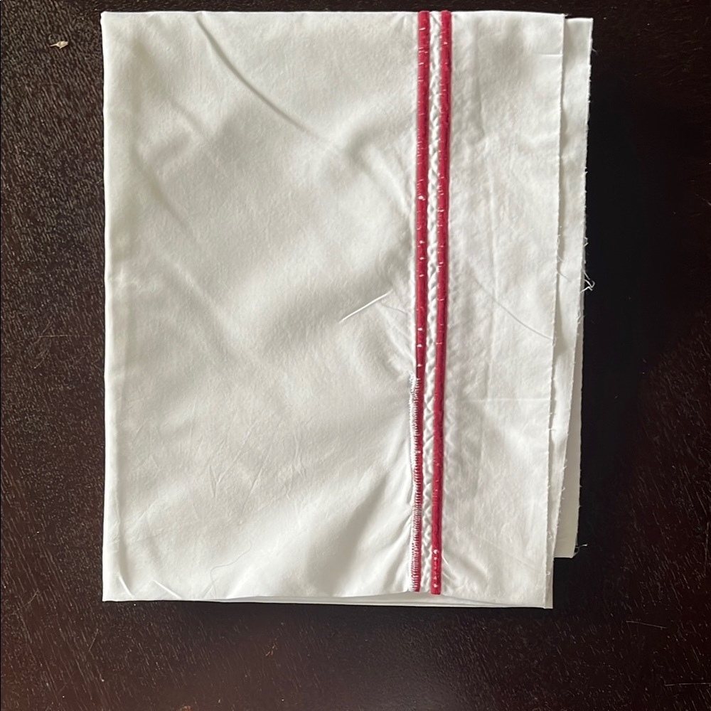 Frette standard pillowcase with satin stitch border.
